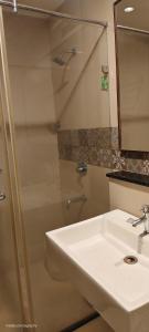 a bathroom with a sink and a shower at Le Aham Boutique Hotel in Kuilapayam +10 photos