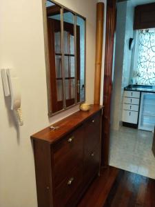 a bathroom with a wooden dresser with a mirror on it at María II in Ferrol