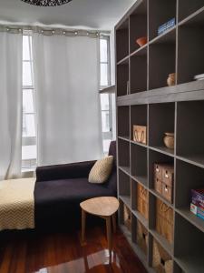 a bedroom with a couch and a book shelf at María II in Ferrol
