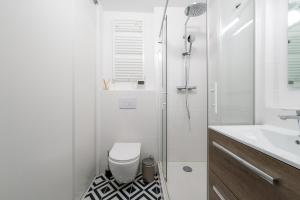 a white bathroom with a toilet and a shower at Best Place - Studio hyper centre ville d'Arras in Arras
