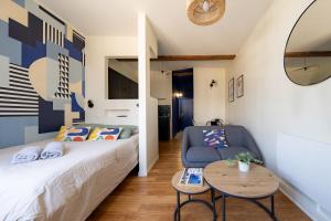 a small bedroom with a bed and a table at Best Place - Studio hyper centre ville d'Arras in Arras