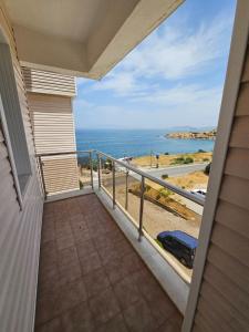 a balcony of a house with a view of the ocean at erşan hotel in Foça