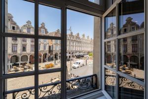 an open window with a view of a city street at Best Place - Studio hyper centre ville d'Arras in Arras