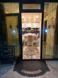 a living room with a table and a chair at Shahdag Cozy House in Qusar