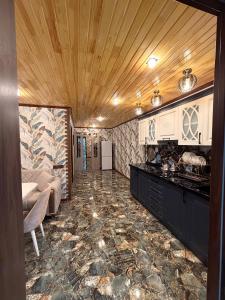 a room with a kitchen with a counter top at Shahdag Cozy House in Qusar
