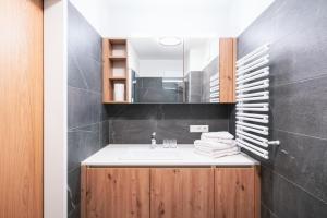a bathroom with a sink and a mirror at KitzSki Living in Kitzbühel +73 photos