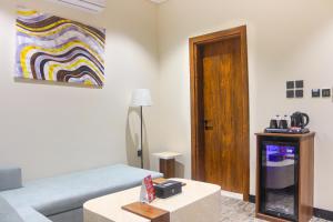 a living room with a couch and a table at فندق تربل ثري in Medina +45 photos