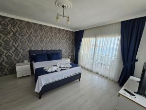 a bedroom with a bed and a television in it at erşan hotel in Foça