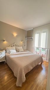a bedroom with a large bed with a white comforter at Petit Rosselló in Barcelona