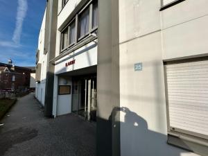 a building with a garage door on the side of it at Appartement moderne et lumineux avec parking privé in Vierzon