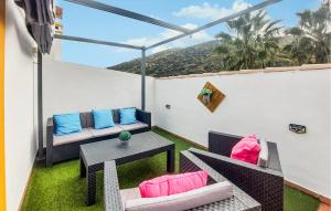 a patio with a table and chairs on a balcony at La Escapadita in Benaoján