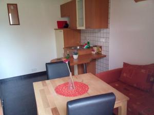 a kitchen with a table with a vase on it at Apartment mit Balkon by Interhome in Gorje