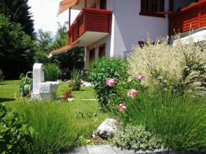 a garden in front of a house with pink flowers at Apartment mit Balkon by Interhome in Gorje