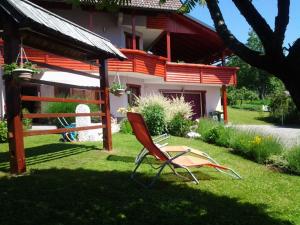 a red chair in the yard of a house at Apartment mit Balkon by Interhome in Gorje
