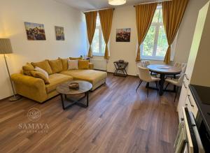 a living room with a couch and a table at Samaya Apartment in Litoměřice