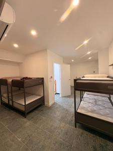 a room with two bunk beds in it at LITTLE Hostel in Puerto de Sagunto +14 photos