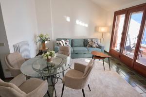 a living room with a glass table and chairs at Villa Belora in Gera Lario +167 photos