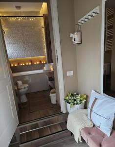 a bathroom with a toilet and a sink at Laci Lak Premium apartment in Oradea +25 photos