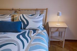 a bedroom with a bed and a nightstand with a lamp at Villa Belora in Gera Lario