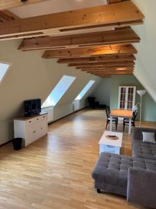 an attic living room with skylights and a couch at Hof Viehbrook in Hollenbek
