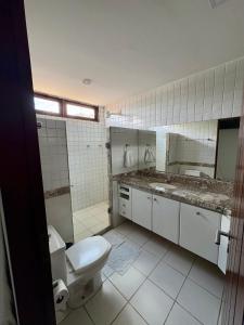a bathroom with a toilet and a sink and a mirror at Lira Hostel in Caruaru +185 photos