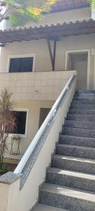 a set of stairs in front of a house at BRISAS DO FAROL casa 208 in Salvador +1 photo
