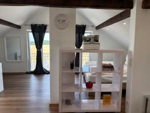 a white book shelf in a room with a bedroom at Vilseck Stay in Vilseck +3 photos