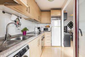 a small kitchen with a sink and a refrigerator at Amazing Sea View! in Isla Plana