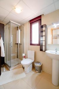 a bathroom with a toilet and a sink and a shower at Amazing Sea View! in Isla Plana +28 photos