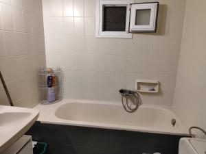 a white bath tub in a bathroom with a window at Φουντούκι in Veria +29 photos