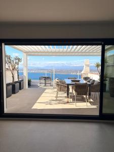 a view of a patio with a table and chairs at Appartement Duplex Rosas avec terrasse magnifique jacuzzi vue mer in Roses
