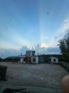 a small house in the middle of a gravel lot at NANGRI Homestay in Pynursla