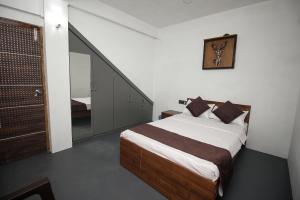a bedroom with a bed and a stair case at NANGRI Homestay in Pynursla