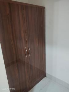 a wooden cabinet with two handles in a room at Hotel Heaven Blu in Hodal