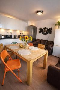 a kitchen with a wooden table with flowers on it at Royal Chambers Liverpool in Liverpool