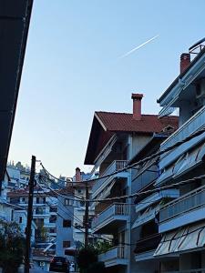 a building with balconies and a red roof at Φουντούκι in Veria