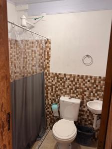 a bathroom with a toilet and a sink at Hotel da Vila in Nova Friburgo
