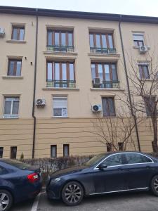 two cars parked in front of a building at ANY MARY Apart ZONA 0 in Tulcea