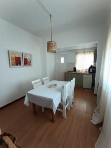 a white dining room with a white table and chairs at San Lorenzo II in Chacabuco
