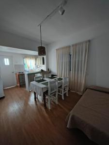 a bedroom with a table and chairs and a kitchen at San Lorenzo II in Chacabuco
