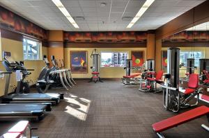 a gym with treadmills and machines in a room at Overton Hotel and Conference Center in Lubbock