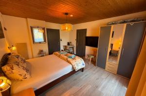 a bedroom with a large white bed in a room at Haus RuHe in Döllach