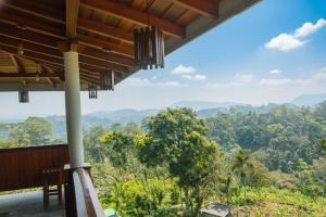 a view from the balcony of a house in the jungle at Udadola Ecolodge in Deniyaya