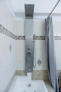 a shower in a bathroom with a shower curtain at Golden Grove in Afantou +33 photos