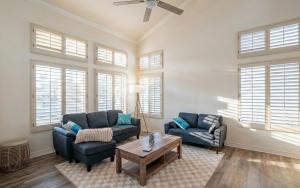 a living room with two blue couches and a table at Luxe 2-Story Oasis with Private Pool & Backyard in Laguna Niguel