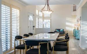 a dining room with a glass table and chairs at Luxe 2-Story Oasis with Private Pool & Backyard in Laguna Niguel