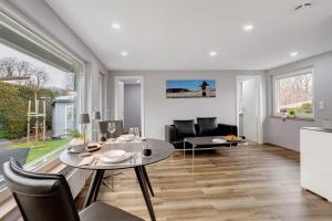 a living room with a table and a couch at Ferienhaus Adelon in Möhnesee +29 photos