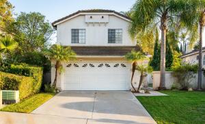 a white house with palm trees and a garage at Luxe 2-Story Oasis with Private Pool & Backyard in Laguna Niguel +30 photos