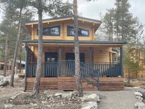 a log cabin in the woods with trees at Chalet neuf proche des stations de ski in Saint-Pons +8 photos
