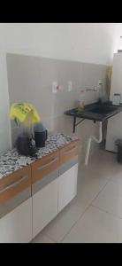 a kitchen with a stove with pots and pans on it at Outeiro in Belém